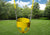Lifestyle shot of the yellow full bucket toddler swing by Gorilla Playsets from the front.