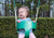Child laughing while swinging in bucket swing by Gorilla Playsets.